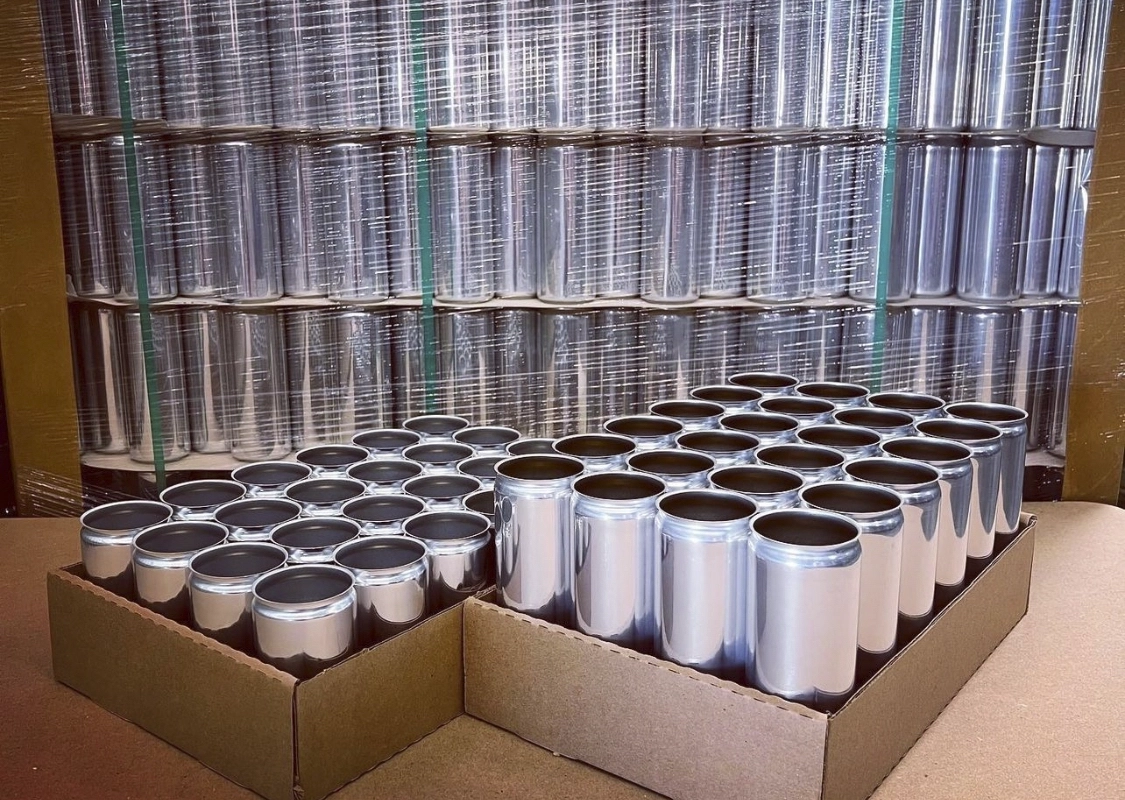 Transparent steel cans on a cardboard box